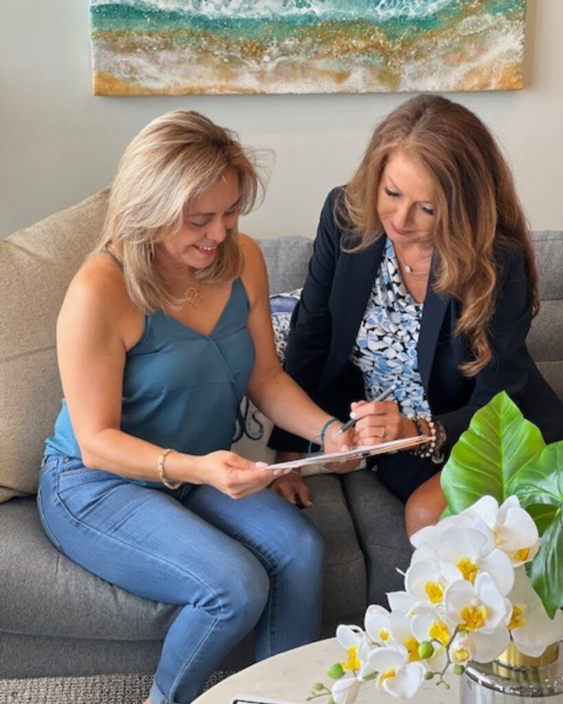 Yvette Trelles sitting down with one of her personal injury clients.