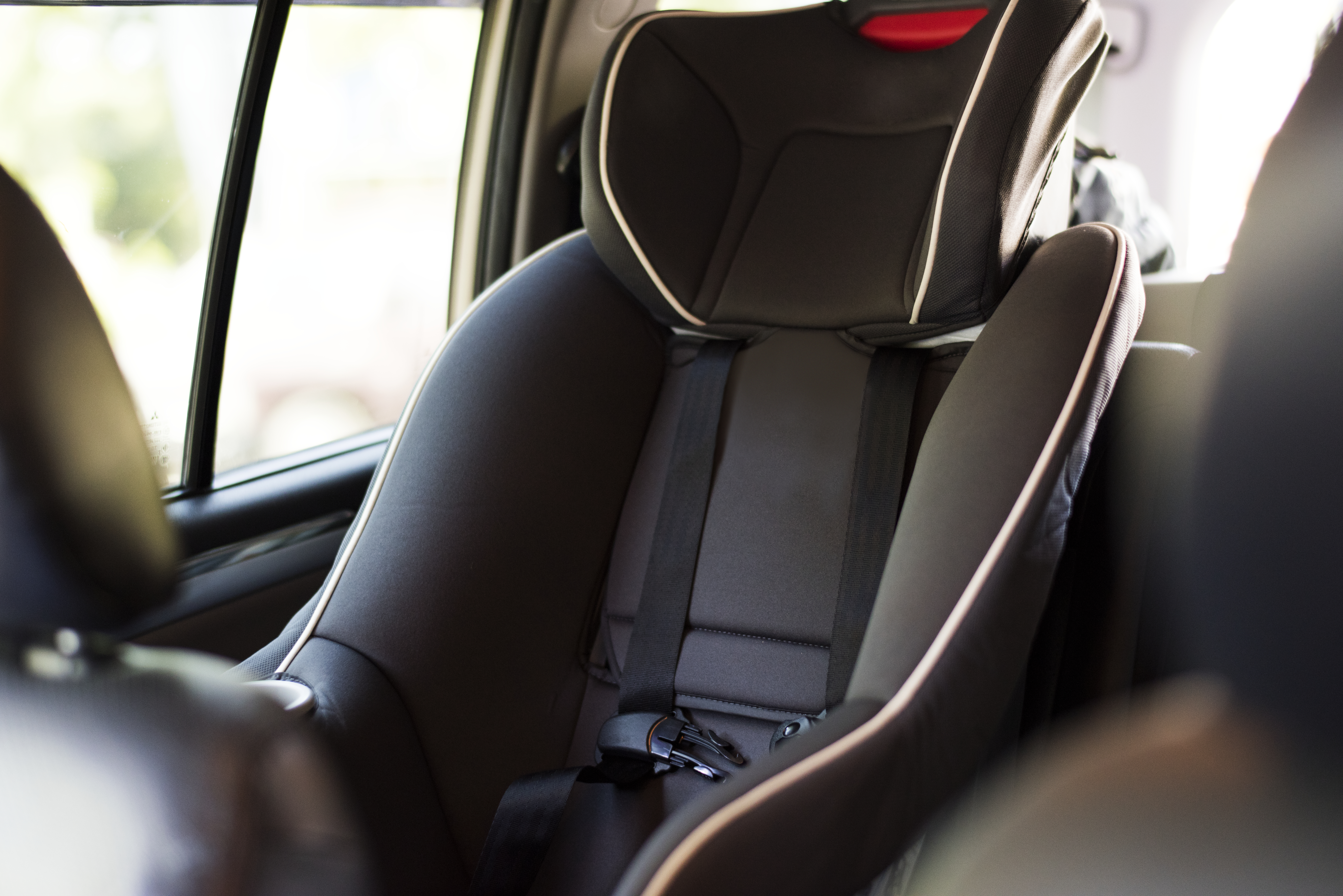 Child safety seat in the back of the car up-close shot of empty children's car seat