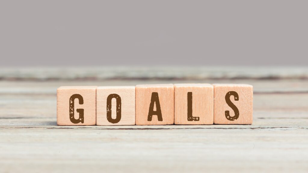 Word Fake on wood cubes small wooden blocks with a letter on them spelling out goals