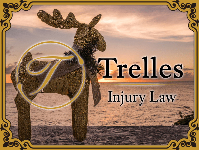 Holiday reindeer decoration by the ocean at sunset with Trelles Injury Law branding.