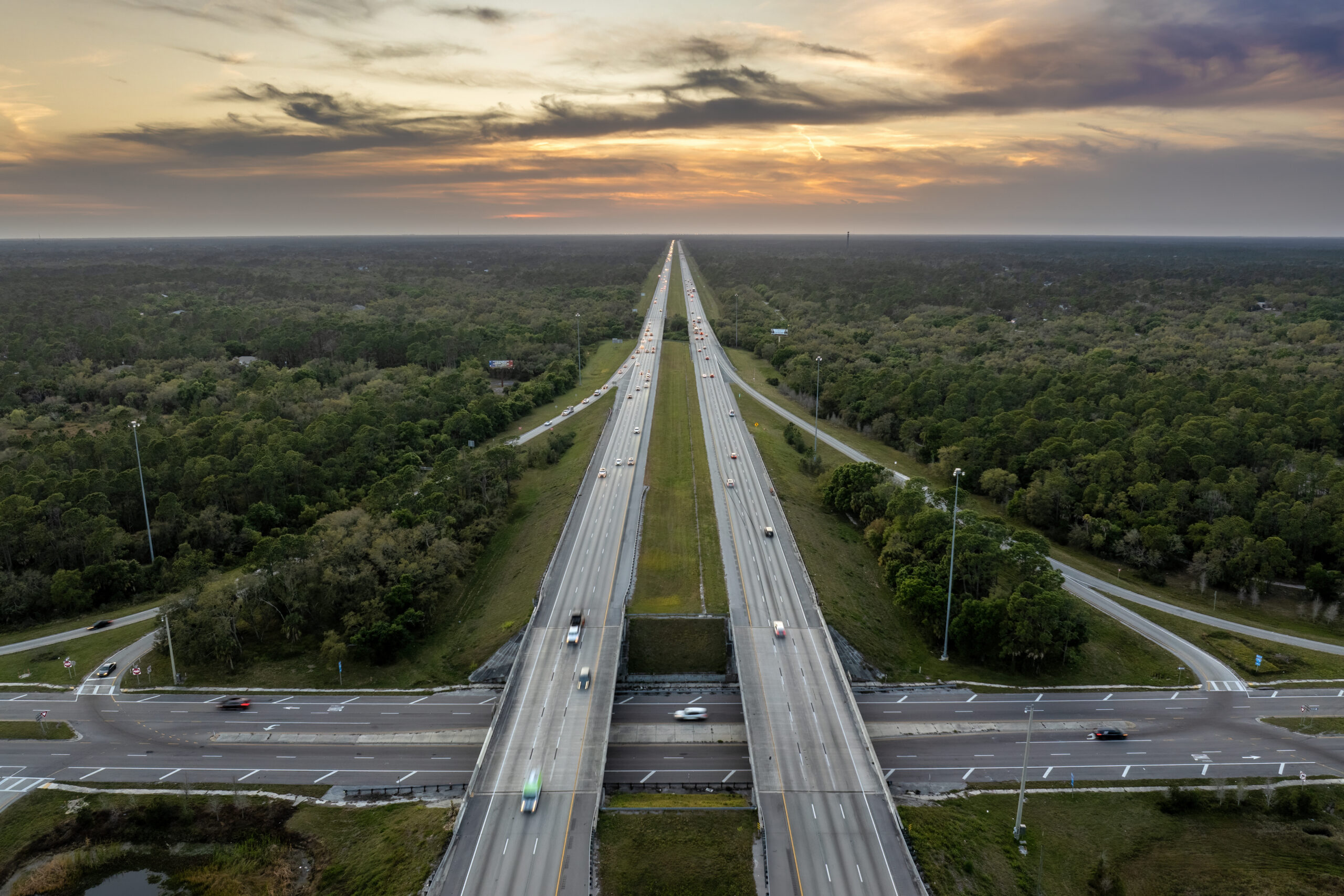 A smartphone lying face-up on a surface with push pins connected by red and blue strings, representing a network of social media connections. Wooden letter tiles spell out the names of apps such as Facebook, Instagram, Snapchat, and iMessage.