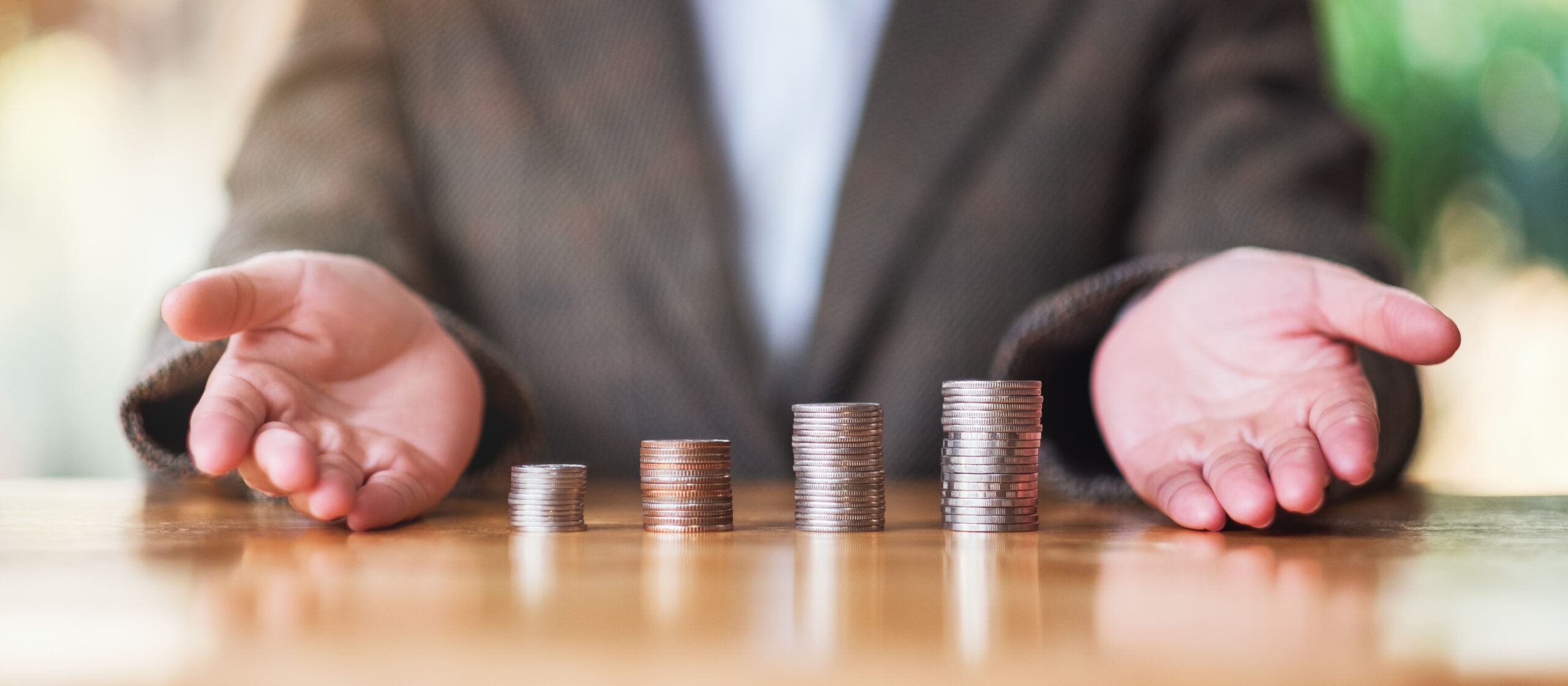 4 different stacks of quarters in front of a man