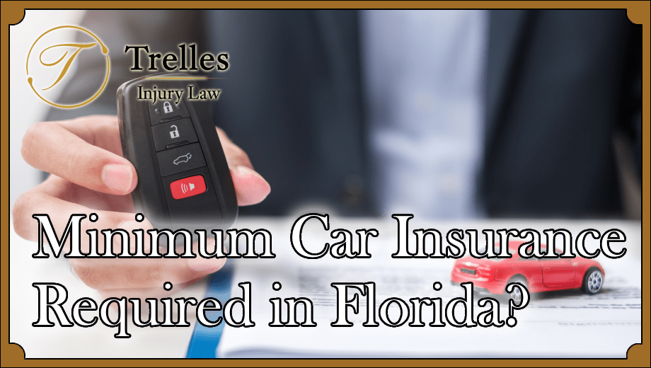 toy car on insurance form and man sitting holding car keys