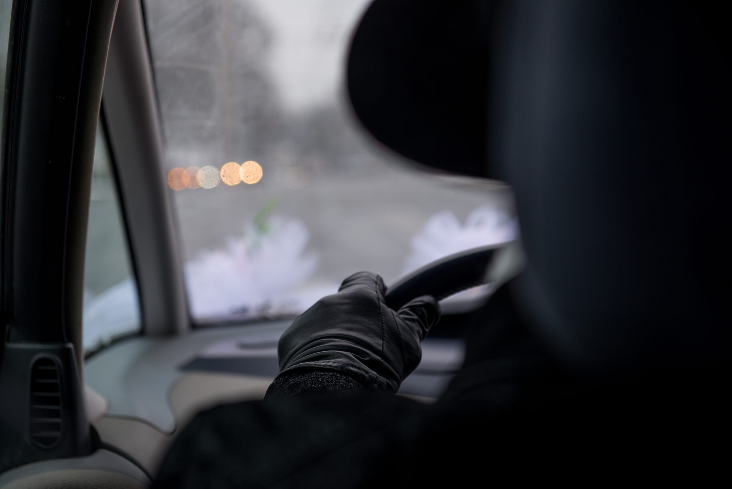 back view in car of thief driving stolen vehicle